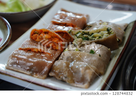 Korean Buckwheat Pancakes with Kimchi and Meat Fillings 128744832