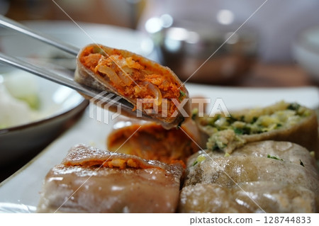 Korean Buckwheat Pancakes with Kimchi and Meat Fillings 128744833