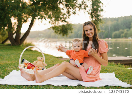 Mother And Baby Enjoying Lake Picnic 128745570