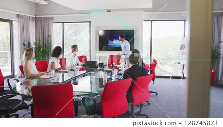 Presenting professional pointing at data graph on screen in meeting room, glass table laptops Presenting professional pointing at data graph on screen in meeting room, glass table laptops 128745871