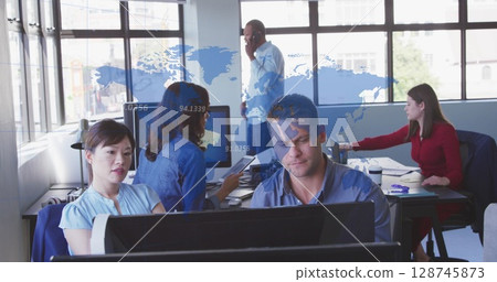 Image of world map against diverse male and female colleagues using computer together at office Image of world map against diverse male and female colleagues using computer together at office 128745873
