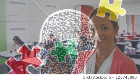 Jigsaw puzzle and human head icon against caucasian female teacher reading a book at school Jigsaw puzzle and human head icon against caucasian female teacher reading a book at school 128745890