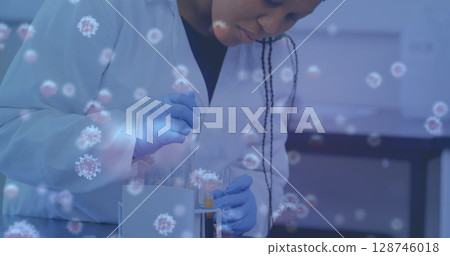 Image of virus cells over female scientist with test tubes 128746018