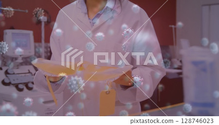 Image of virus cells over female scientist with bags Image of virus cells over female scientist with bags 128746023