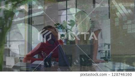 Statistical data processing against two diverse female office colleagues discussing at office Statistical data processing against two diverse female office colleagues discussing at office 128746160