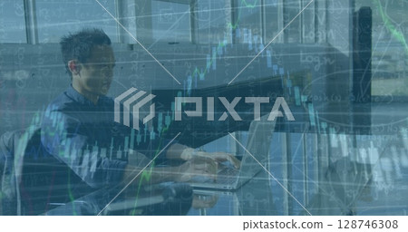Image of financial data processing over asian male engineer using laptop at office Image of financial data processing over asian male engineer using laptop at office 128746308