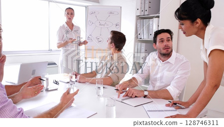 Leading businesswoman in blouse guiding discussion in conference room, with flip chart, copy space 128746311