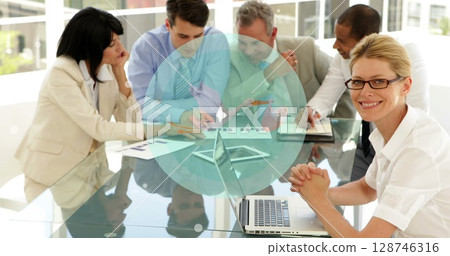 Image of globe over happy diverse businesspeople working together in office 128746316