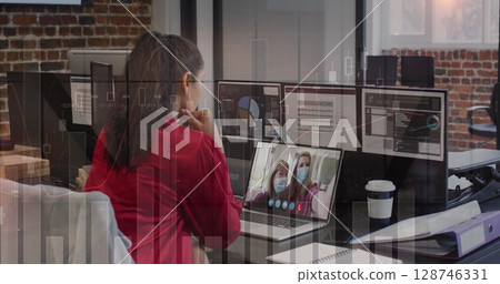 Statistical data processing over rear view of a woman having a image call on laptop at office Statistical data processing over rear view of a woman having a image call on laptop at office 128746331