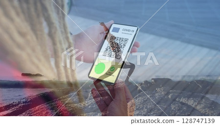 Image of man with covid passport on smartphone over woman practicing yoga on beach Image of man with covid passport on smartphone over woman practicing yoga on beach 128747139
