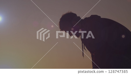 Image of image of lights over caucasian man on beach Image of image of lights over caucasian man on beach 128747385