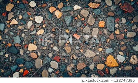 Close up of colorful pebbles embedded in concrete surface Close up of colorful pebbles embedded in concrete surface 128747396