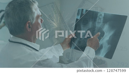 Image of fireworks and banknotes over caucasian male doctor 128747599