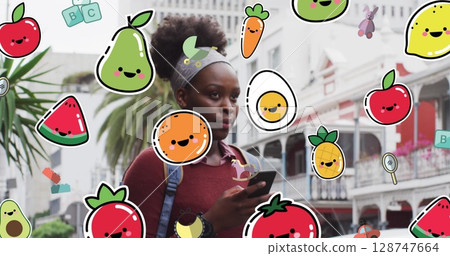 Image of food and toys icons over african american woman using smartphone Image of food and toys icons over african american woman using smartphone 128747664