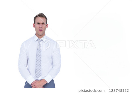 Male standing against white backdrop in studio wearing white shirt grey tie trousers, copy space Male standing against white backdrop in studio wearing white shirt grey tie trousers, copy space 128748322