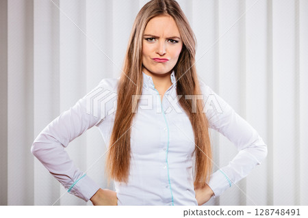 Angry and irritated business woman in office. Angry and irritated business woman in office. 128748491
