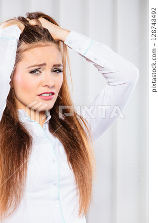 Stressed young woman pulling hair. Stressed young woman pulling hair. 128748492