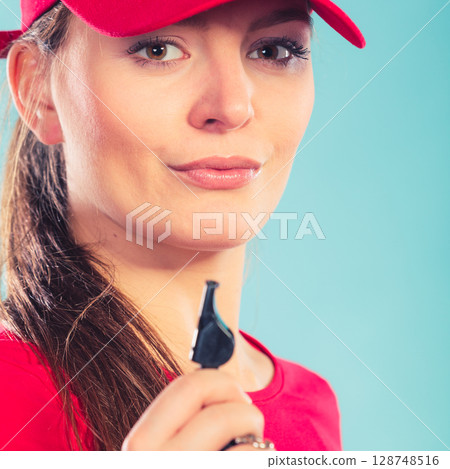 Lifeguard woman in cap on duty with whistle. Lifeguard woman in cap on duty with whistle. 128748516