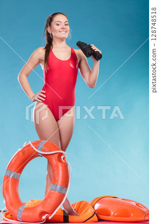 Lifeguard woman on duty with ring buoy lifebuoy. 128748518