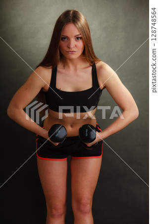 Fit woman exercising with dumbbells. Fit woman exercising with dumbbells. 128748564