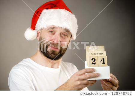 Christmas santa man holding calendar Christmas santa man holding calendar 128748792