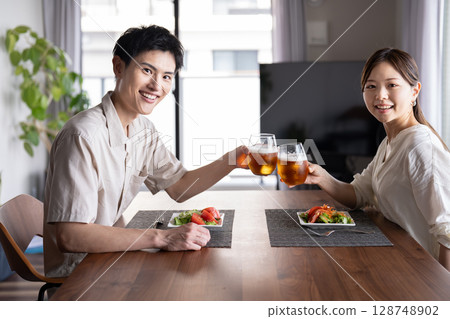 Couple enjoying beer at home Couple enjoying beer at home 128748902