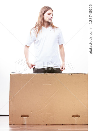 Delivery man holding a paper box. Delivery man holding a paper box. 128748996