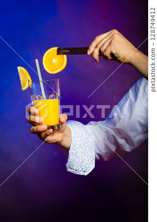 Young man bartender preparing alcohol cocktail drink Young man bartender preparing alcohol cocktail drink 128749412