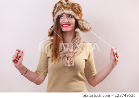 Winter woman in warm clothing fur cap 128749525