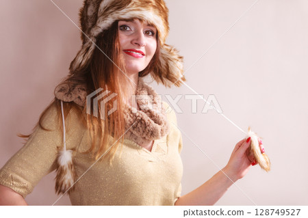 Winter woman in warm clothing fur cap Winter woman in warm clothing fur cap 128749527