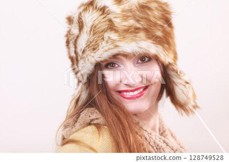 Winter woman in warm clothing fur cap Winter woman in warm clothing fur cap 128749528