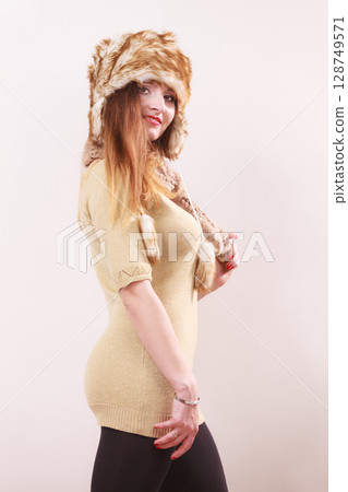 Winter woman in warm clothing fur cap 128749571