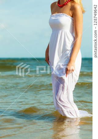 Young woman chilling out on the beach. 128749642