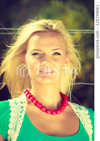 Sunny portrait of nice woman. Sunny portrait of nice woman. 128749661