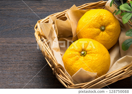 Fresh yuzu in a basket Fresh yuzu in a basket 128750088