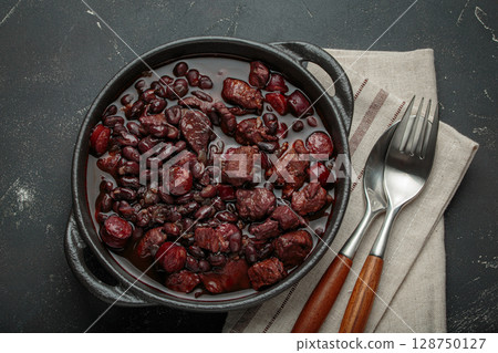 Brazilian feijoada with black beans, sausage and meat in a pot, top view Brazilian feijoada with black beans, sausage and meat in a pot, top view 128750127