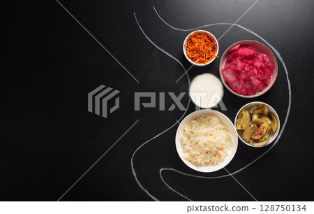 Probiotic foods for gut health inside stomach outline drawn on black chalk board top view Probiotic foods for gut health inside stomach outline drawn on black chalk board top view 128750134