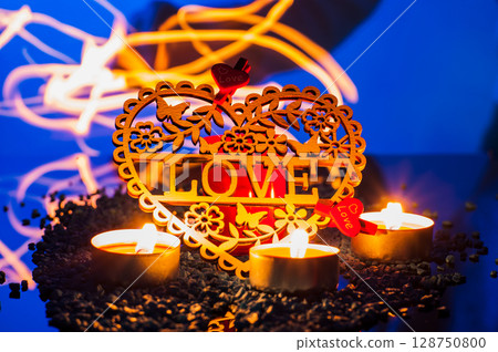 Candlelight gently spreads across the surface, surrounding the heart-shaped valentine Candlelight gently spreads across the surface, surrounding the heart-shaped valentine 128750800