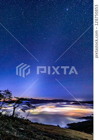 Panorama of Tono's night sky and the sea of clouds with shining city lights Panorama of Tono's night sky and the sea of clouds with shining city lights 128750853