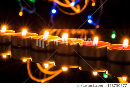 Countless small candles gently flicker in the deep darkness Countless small candles gently flicker in the deep darkness 128750877