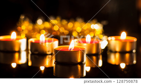 Dozens of candles shine like sparks of hope in the darkness Dozens of candles shine like sparks of hope in the darkness 128750878