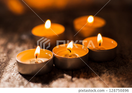 The frame shows dozens of burning candles that create a magical effect 128750896