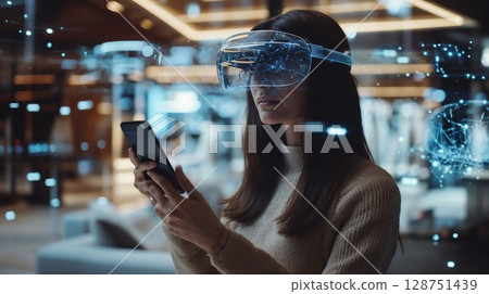 Woman wearing VR headset using smartphone with augmented reality visualization. Futuristic mixed reality technology concept with holographic network elements in modern interior setting 128751439
