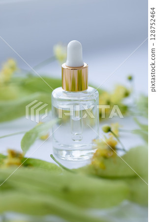 linden extract in a small glass bottle. Closeup. 128752464