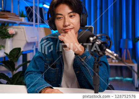 Focused podcaster listening during session 128752576