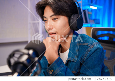 Close-up podcaster with headphones speaking Close-up podcaster with headphones speaking 128752580