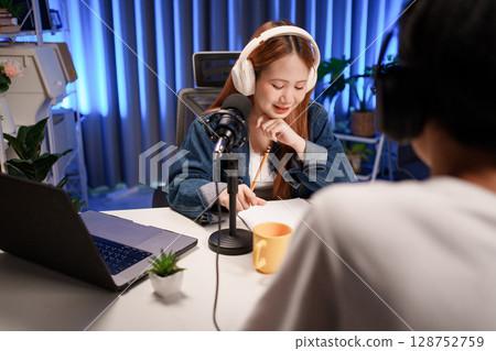 People in the podcast studio talking and recording 128752759