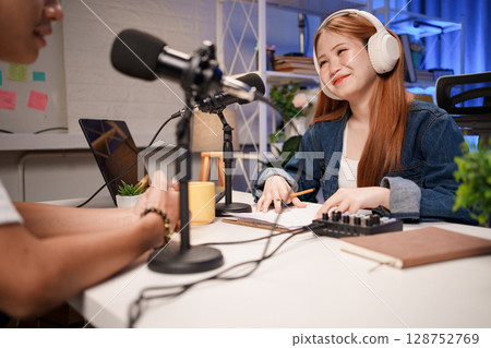 People in the podcast studio talking and recording People in the podcast studio talking and recording 128752769