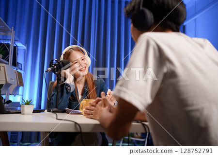 People in the podcast studio talking and recording 128752791