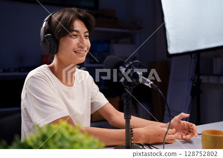 Female podcaster interviewing a guest in a recording studio Female podcaster interviewing a guest in a recording studio 128752802